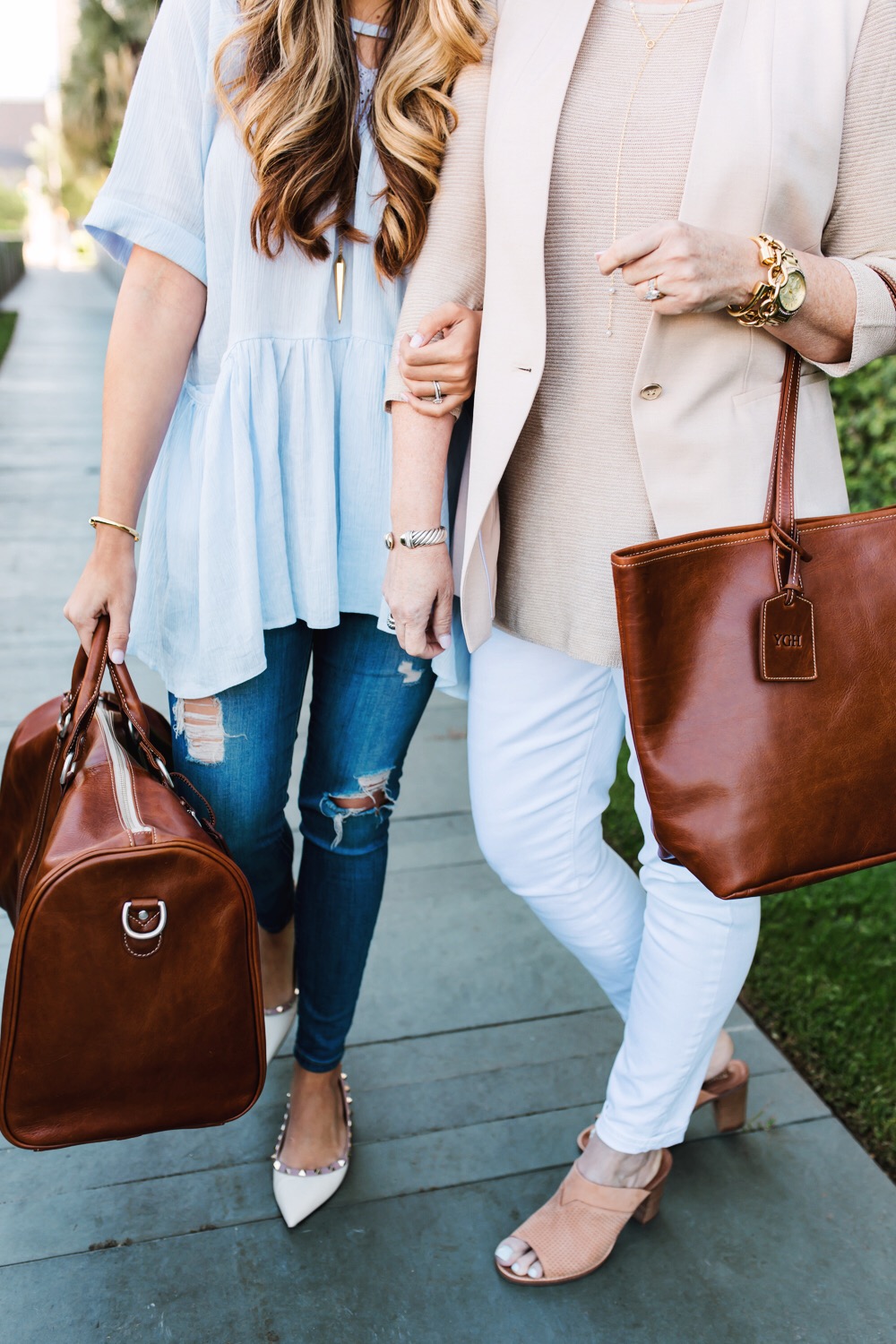 Ashley Robertson carrying leather duffle bag