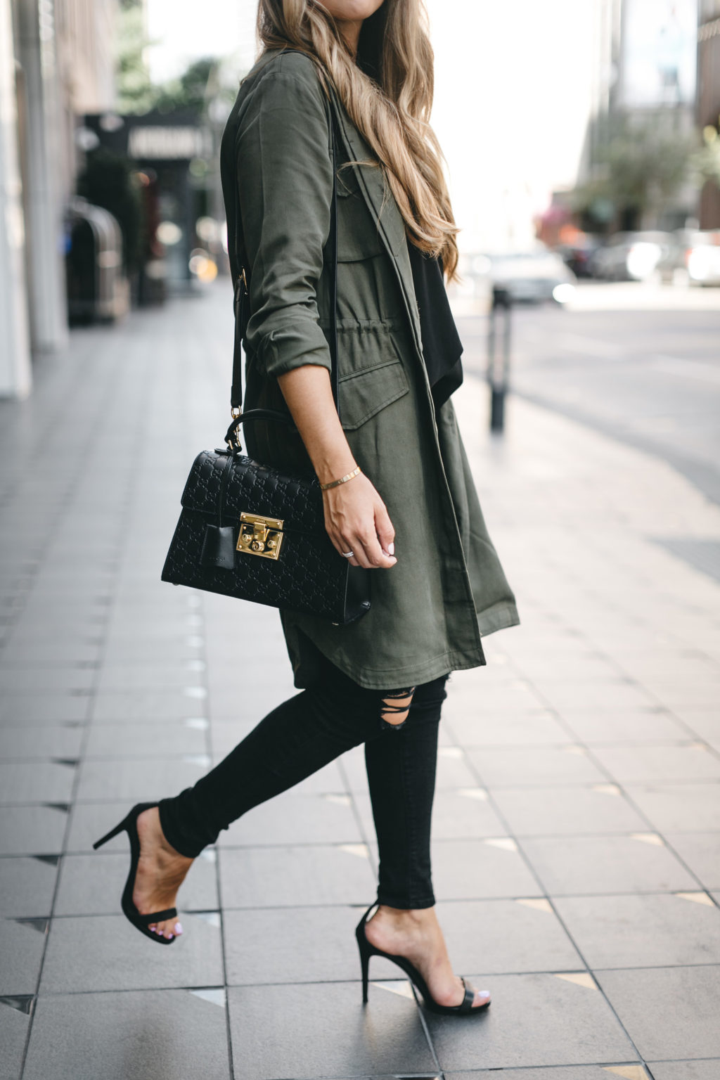 Black heels and army green trench coat