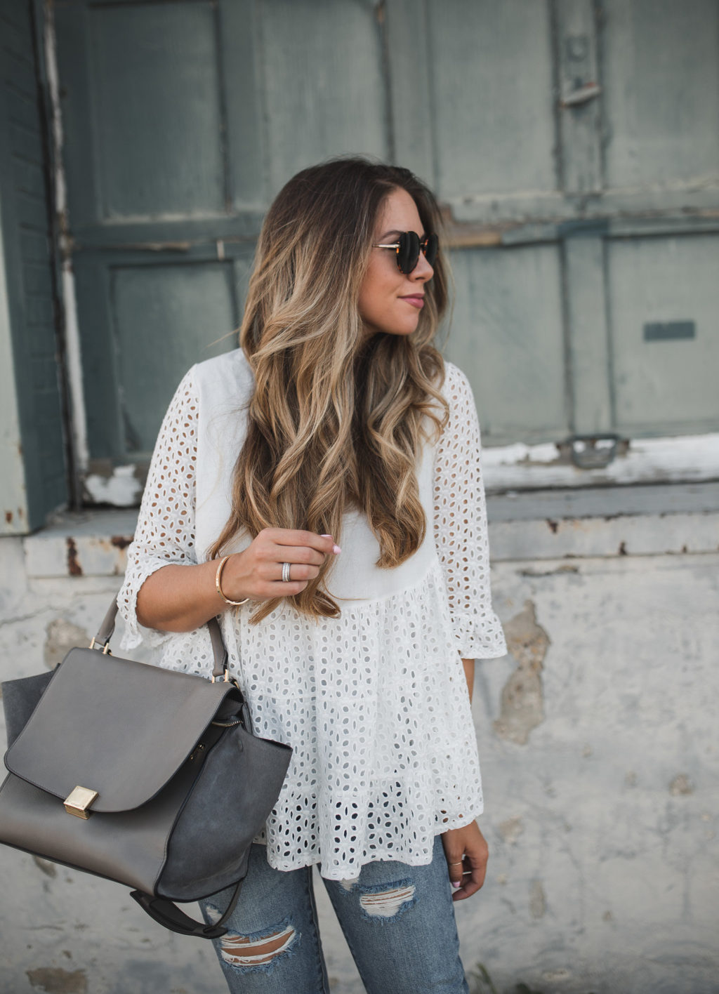 Eyelet blouse and ripped jeans
